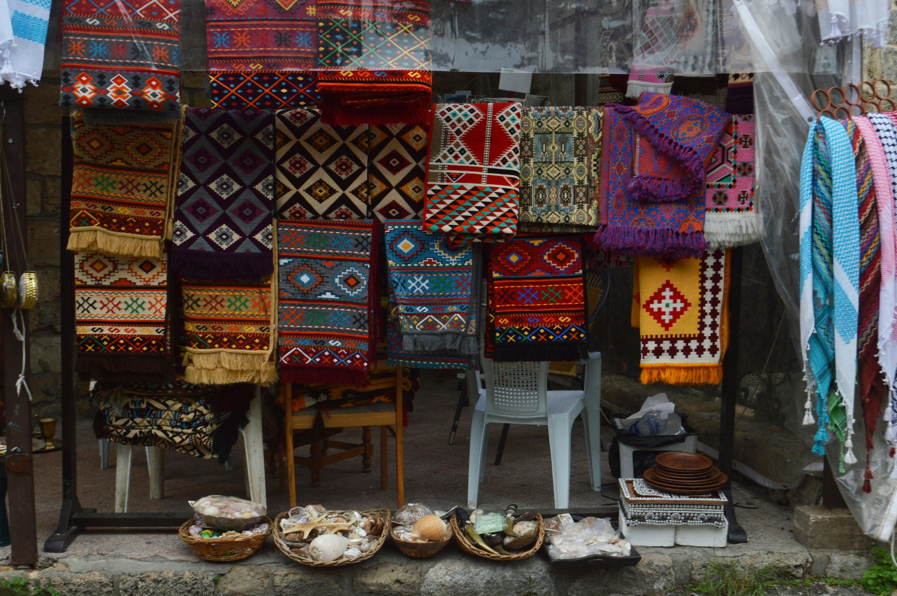 A display of colourful carpets and rugs in a shop.